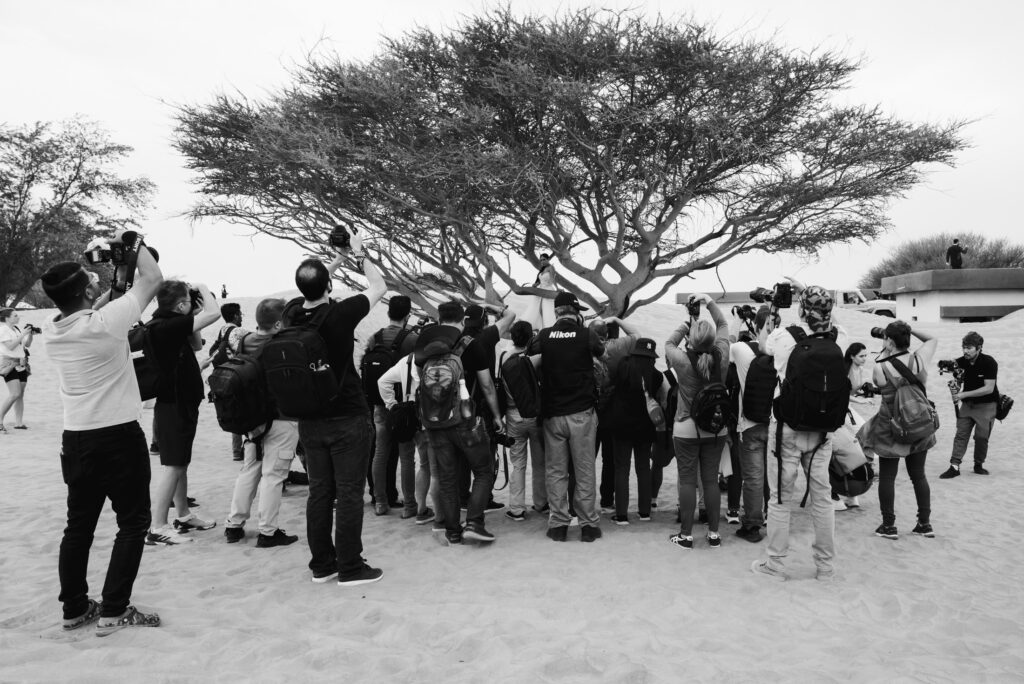 Black and white image of a photography workshop in the desert