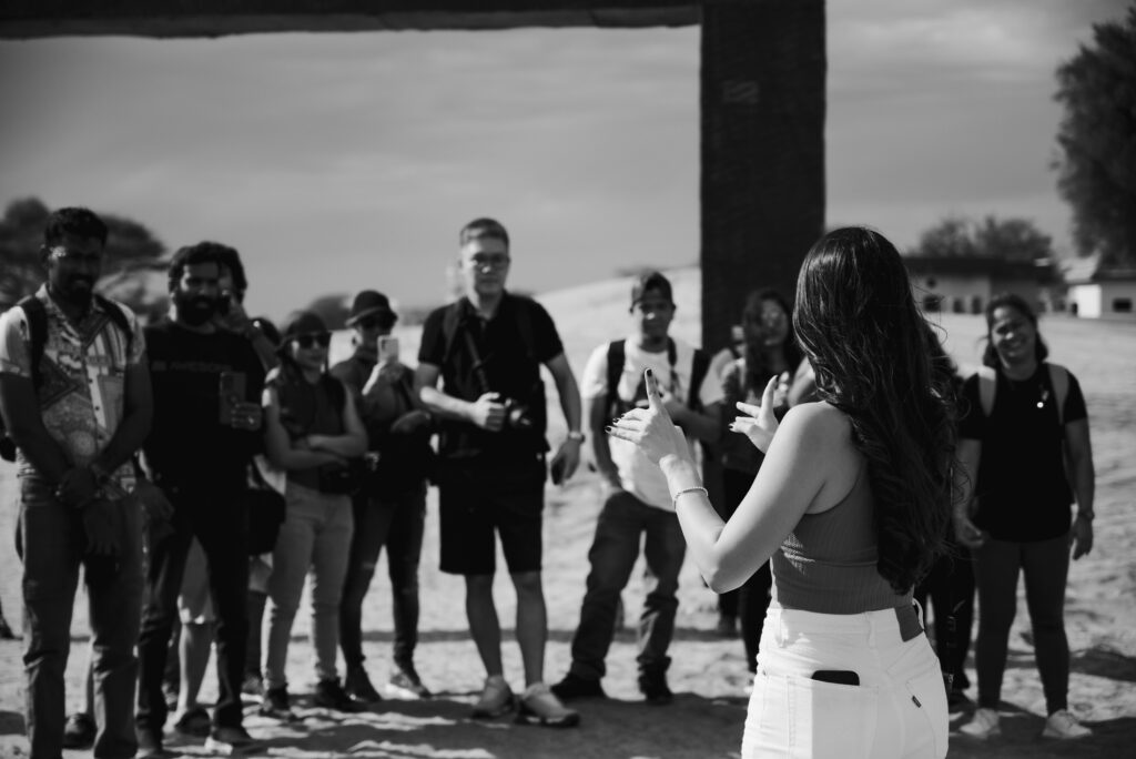 Black and white image of a n instructor at photography workshop in the desert